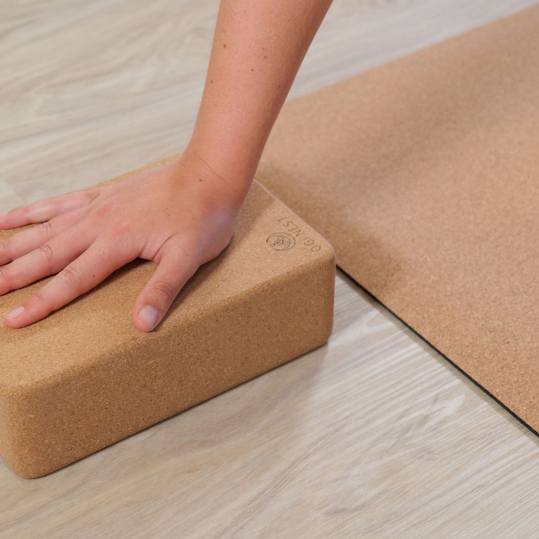 Woman using unalome lotus cork block for support.