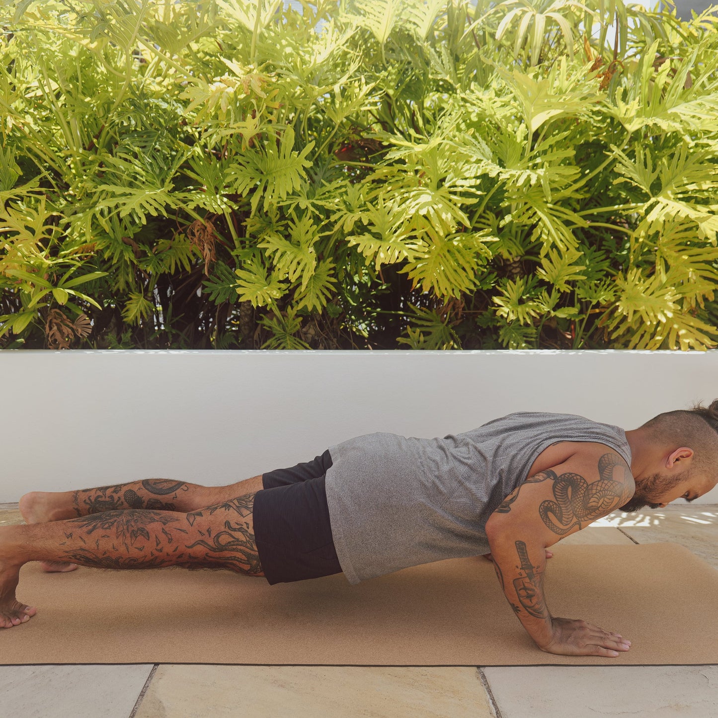 Man performing plank on original cork and natural rubber yoga mat.