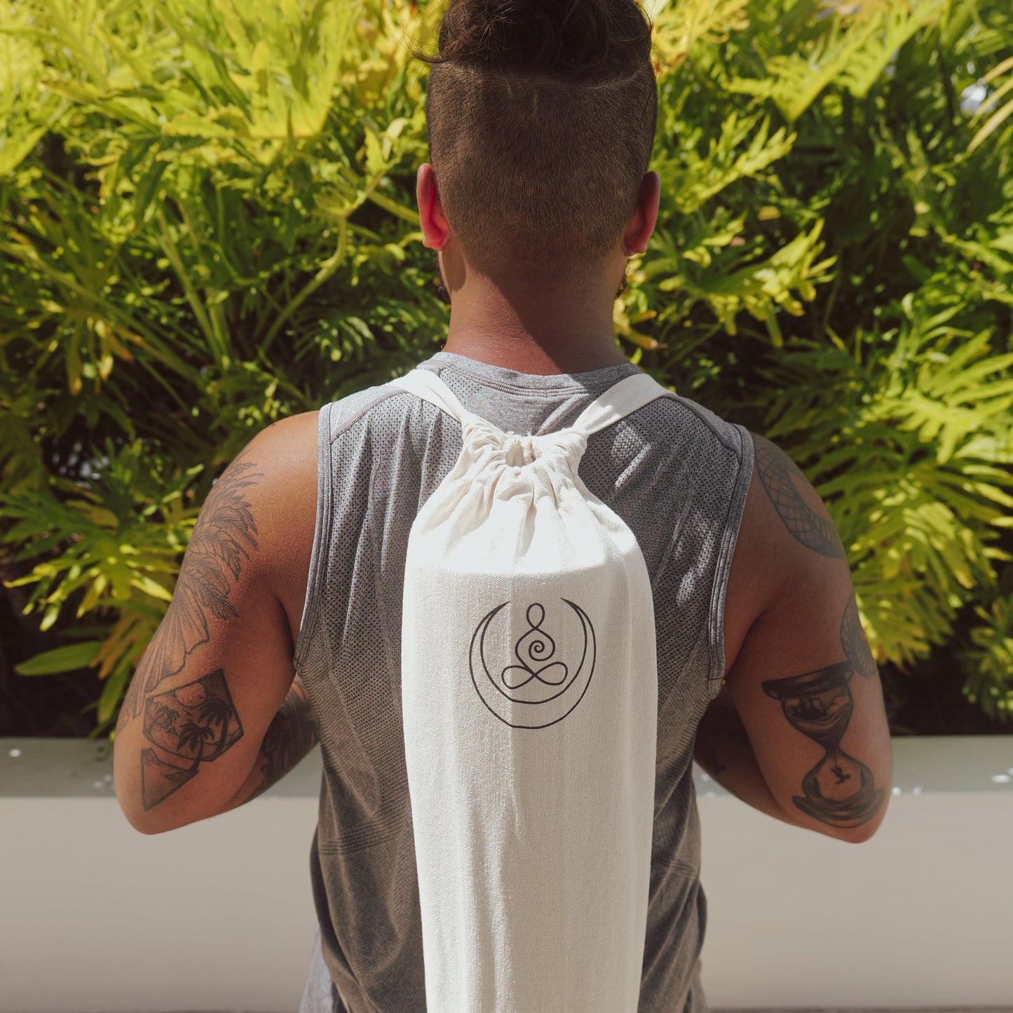 One man wearing OGI NEST cotton canvas yoga mat carry bag.